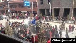 Citizen journalist image shows crowds surrounding Dorjee Rinchen, a Tibetan man who self-immolated in Labrang, China, October 23, 2012.