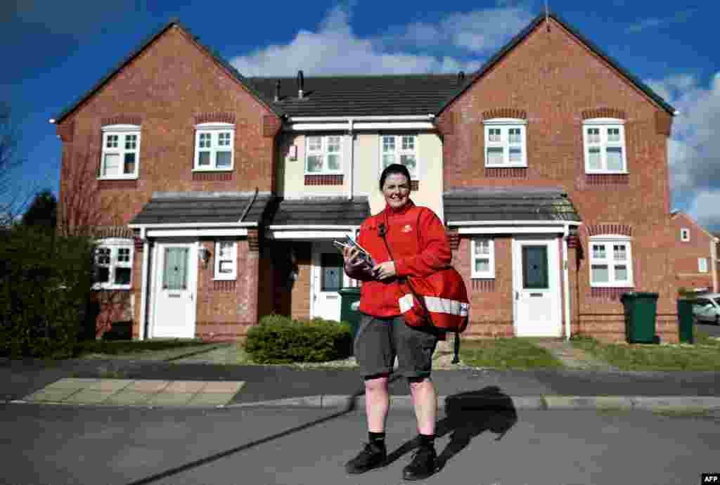 Cilene Connolly, 32, a Royal Mail postwoman, poses for a portrait during her postal round on a residential street in Coventry, Britain, Feb. 24, 2017. &quot;Fortunately, I haven&#39;t been faced with gender inequalities in my role as a postwoman,&quot; Connolly said. &quot;I&#39;ve had a great response from my customers for being a female delivering their post, women in particular are always pleasantly surprised to see a female face.&quot;