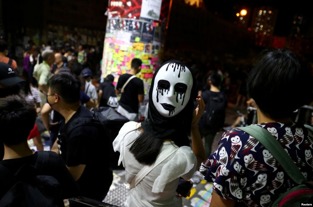 An anti-government protester wears a mask on the back of her head during a demonstration in Wong Tai Sin district, in Hong Kong, China.