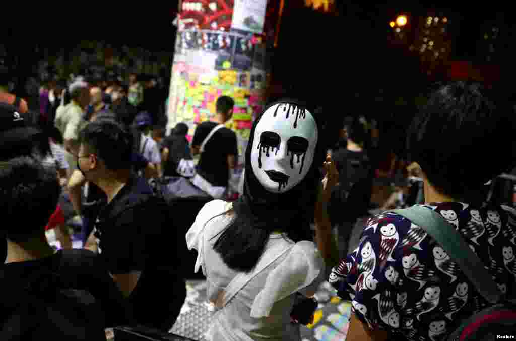 An anti-government protester wears a mask during a demonstration in Wong Tai Sin district, in Hong Kong, China.