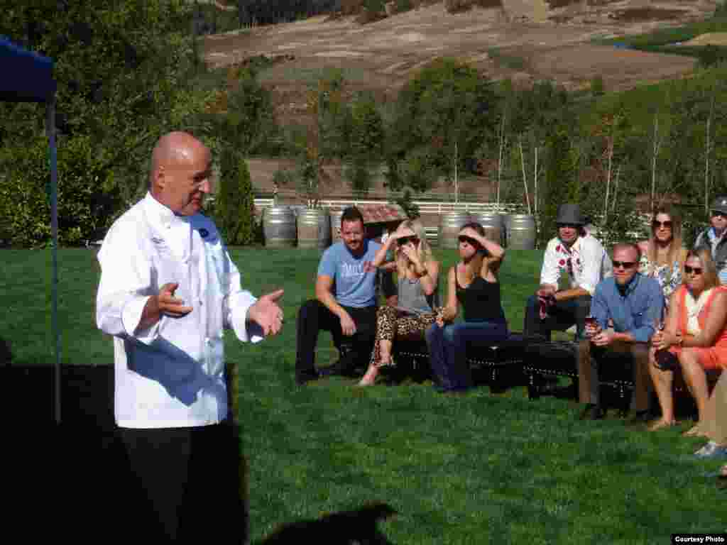 Chef Philippe Parola speaks to attendees at a Eradication by Mastication dinner at Zenith Vineyard. (Tom Banse) 