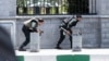 FILE - Members of Iranian forces take cover during an attack on the Iranian parliament in central Tehran, Iran, June 7, 2017. 