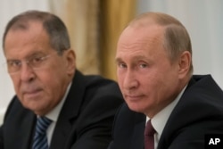 FILE - Russian President Vladimir Putin, right, and Russian Foreign Minister Sergey Lavrov attend talks with U.S. National security adviser John Bolton in the Kremlin in Moscow, Russia, June 27, 2018.