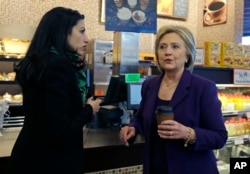 FILE - Democratic presidential candidate Hillary Clinton, right, chats with her aide, Huma Abedin during a campaign stop at Market Basket Supermarket, Feb. 2, 2016, in Manchester, N.H.