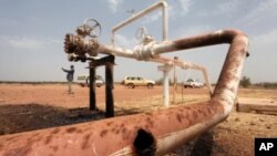 Oil spills onto the ground from an oil well head strafed by shrapnel from a bomb dropped by fighter jets at the El Nar oil field in South Sudan's Unity State, March 3, 2012.