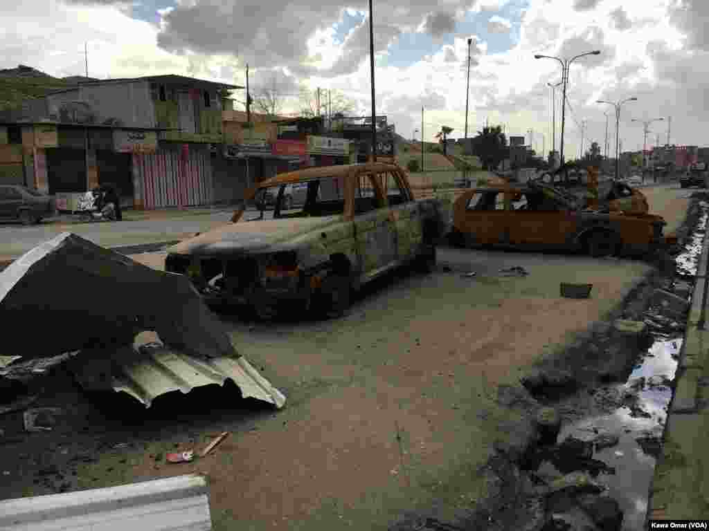 Burned vehicles in front of Nabi Yunis Shrine on a public road in east of Mosul, Iraq.