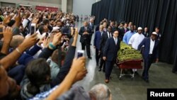 Worshipers and well-wishers take photographs as the casket with the body of the late boxing champion Muhammad Ali is brought for his jenazah, an Islamic funeral prayer, in Louisville, Kentucky, June 9, 2016.