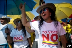 Demonstrators yell "No to the plebiscite" to protest the government's peace agreement with the Revolutionary Armed Forces of Colombia (FARC), to be signed later in the day in Cartagena, Colombia, Sept. 26, 2016.