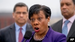 NEA Vice President Becky Pringle, center, accompanied by California Attorney General Xavier Becerra, left, and District of Columbia Attorney General Karl Racine, right, speaks at a news conference near the White House, Monday, Feb. 26, 2018. (AP Photo)