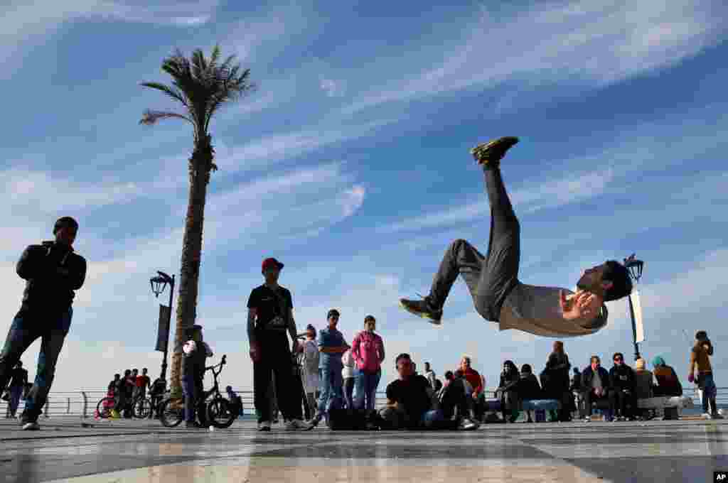 Syrian refugee Mohammed al-Shareef, who fled with his family from Damascus, performs a breakdance on the Mediterranean waterfront promenade in Beirut, Lebanon.