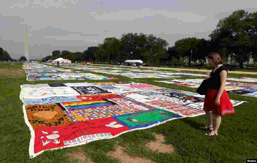 A woman looks out over the AIDS Memorial Quilt, which is now in its 25th year, on the National Mall in Washington July 24, 2012.