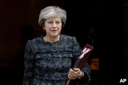 FILE - British Prime Minister Theresa May leaves 10 Downing Street in London, to attend the prime minister's questions at the Houses of Parliament, Sept. 13, 2017.