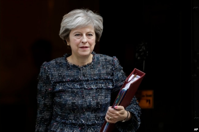 FILE - British Prime Minister Theresa May leaves 10 Downing Street in London, to attend the prime minister's questions at the Houses of Parliament, Sept. 13, 2017.