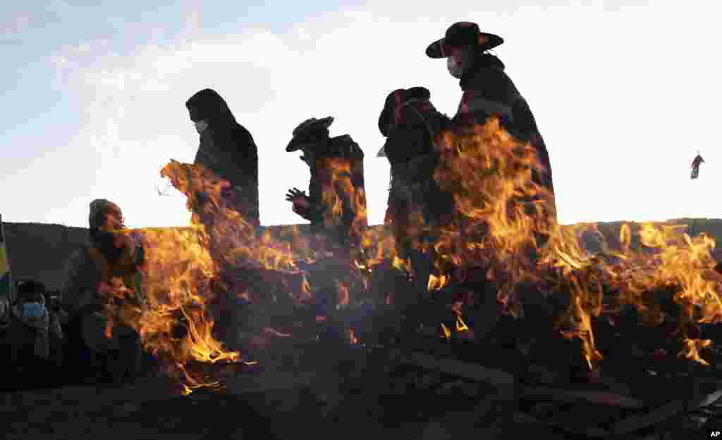 Aymara Indigenous religious leaders finish a New Year's ritual at the ancient city of Tiwanaku, Bolivia. The Aymara are celebrating the Andean New Year of 5,529 as well as the Southern Hemisphere's winter solstice, which marks the start of a new agricultural cycle.
