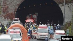 Police officers and firefighters gather in front of the Sasago Tunnel on the Chuo Expressway in Otsuki, Yamanashi prefecture, in this photo taken by Kyodo December 2, 2012. 