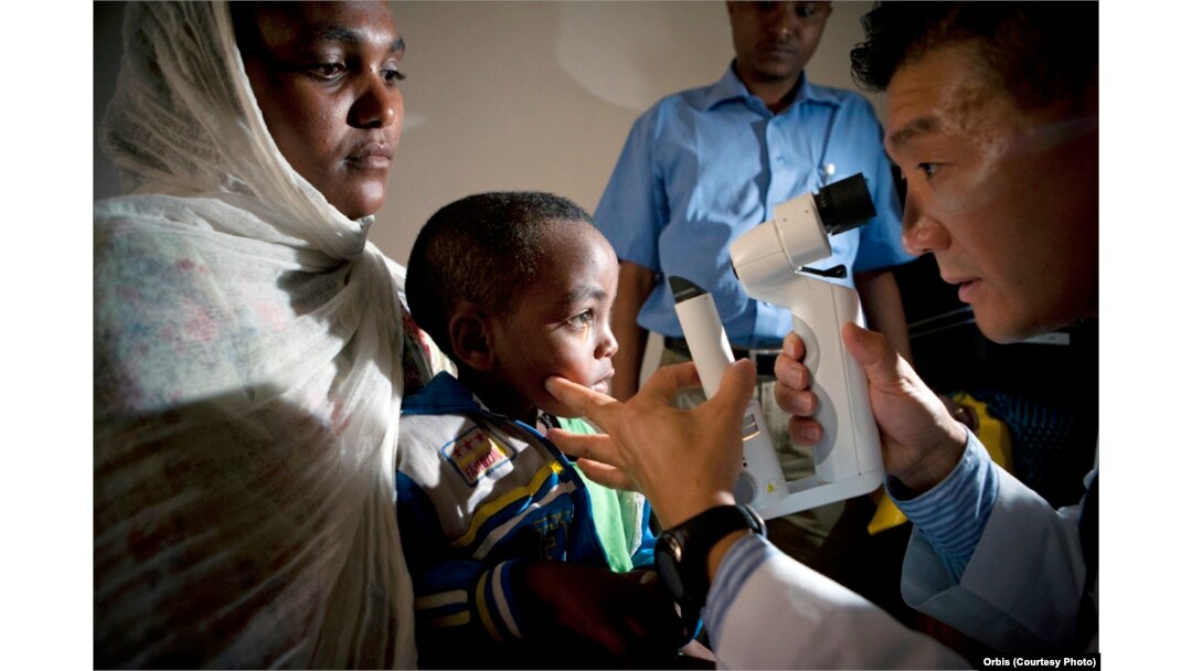 FILE - Screening of a pediatric patients by Dr. Donny Suh in Gondar, Ethiopia, Oct. 2012. Dr. Suh is a cataract and strabismus specialist from Des Moines, Iowa.
