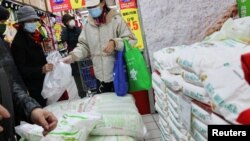 Warga membeli beras di sebuah supermarket di tengah pandemi COVID-19 di Beijing, China, 3 November 2021. (REUTERS/Thomas Peter)