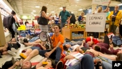 David Hogg, center, and fellow students protest as they lie on the floor at a Publix Supermarket in Coral Springs, Florida, May 25, 2018.