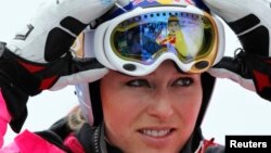FILE - Overall leader of Alpine Skiing World Cup, Lindsey Vonn of the U.S. takes off her mask at the finish area of the Rosa Khutor Alpine skiing, in Krasnaya Polyana near Sochi, Feb. 19, 2012.