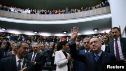 Turkish President Recep Tayyip Erdogan greets members of parliament from his ruling AK Party during a meeting in Ankara, April 24, 2018. 