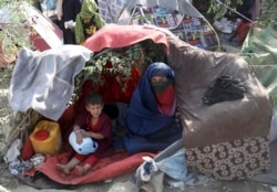 Internally displaced Afghans from northern provinces, who fled their home due to fighting between the Taliban and Afghan security personnel, take refuge in a public park Kabul, Afghanistan, Friday, Aug. 13, 2021. (AP Photo/Rahmat Gul)