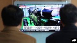 People watch a TV screen showing a local news program reporting on a North Korean missile launch, at the Seoul Railway Station in Seoul, South Korea, Nov. 30, 2017. 