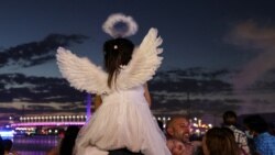 A child wears angel wings while families celebrate New Year's Eve on the Yarra River waterfront, as the Omicron variant of the coronavirus disease (COVID-19) continues to spread, in Melbourne, Australia, Dec. 31, 2021.