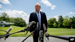 FILE - President Donald Trump listens to a question from a member of the media on the South Lawn of the White House in Washington, May 14, 2019.