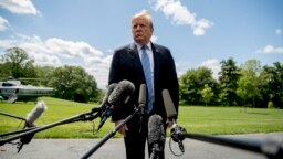 FILE - President Donald Trump listens to a question from a member of the media on the South Lawn of the White House in Washington, May 14, 2019.