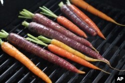 FILE - This April 20, 2015 photo shows grilled carrots in Concord, N.H. (AP Photo/Matthew Mead)