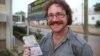 Graham Hughes brandishing his latest visa outside South Sudan's Ministry of Roads in the capital Juba. The 33-year-old Liverpudlian broke a world record Monday when he reached South Sudan, the last on his list of 201 sovereign states to visit without flyi