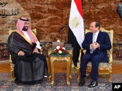 In this photo released by the Egyptian presidency's office, Saudi Arabia's Crown Prince Mohammed bin Salman, left, meets with Egyptian President Abdel Fattah el-Sisi in Cairo, Nov. 27, 2018.