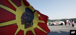 A law enforcement officer passes a tax protest on the Tuscarora Indian Nation in New York, Sept. 1, 2010. A federal judge had temporarily blocked New York state's plans to tax cigarette sales by two Native American Nations to non-Native customers; tribes challenged the policy shift as a threat to their sovereignty.