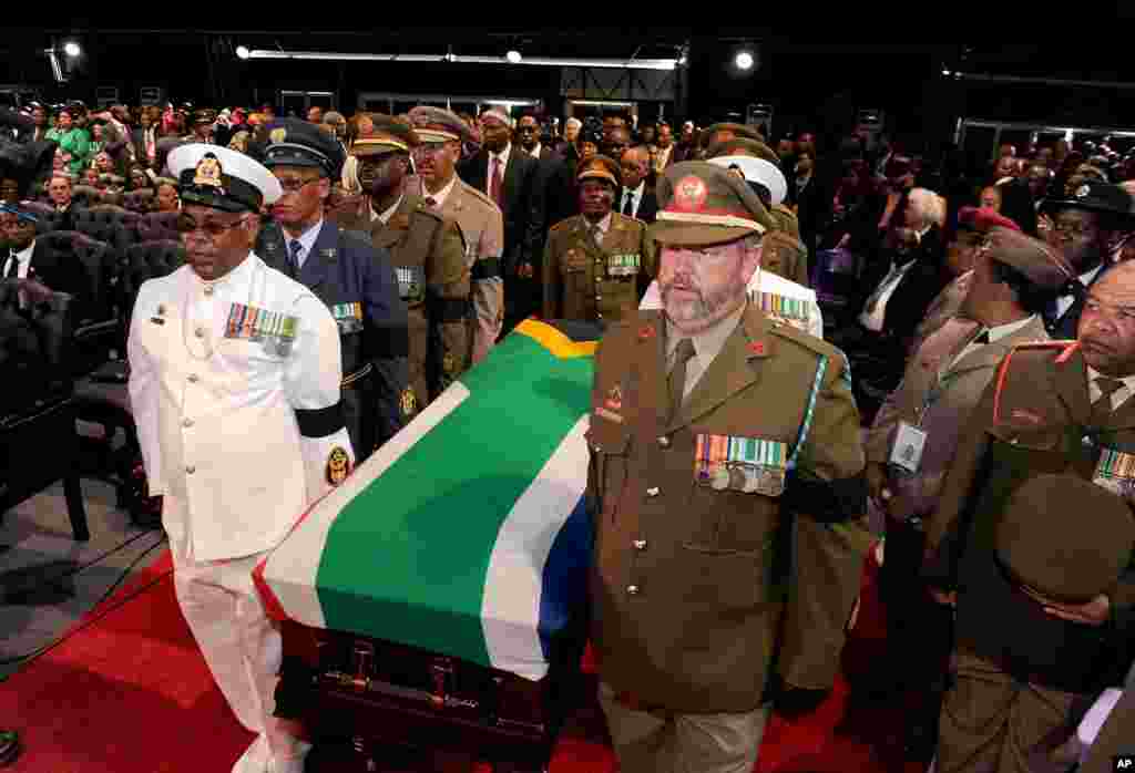 The casket bearing the remains of former South African President Nelson Mandela is brought into a tent for his funeral service for in Qunu.