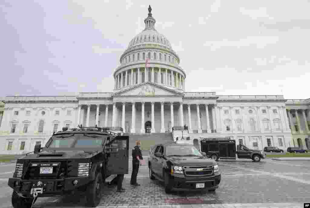 U.S. Capitol Police personnel keep watch on the East Plaza of the Capitol as the investigation continues to the shooting at the nearby Washington Navy Yard, Sept. 16, 2013.