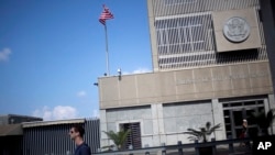 FILE - A man walks past the U.S. Embassy in Tel Aviv, Israel, Aug. 4, 2013. President-elect Donald Trump has indicated during the election campaign that he would move the embassy to Jerusalem.
