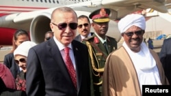 FILE - Sudan’s President Omar al-Bashir welcomes Turkey's President Recep Tayyip Erdogan at Khartoum Airport, Sudan, Dec. 24, 2017. 