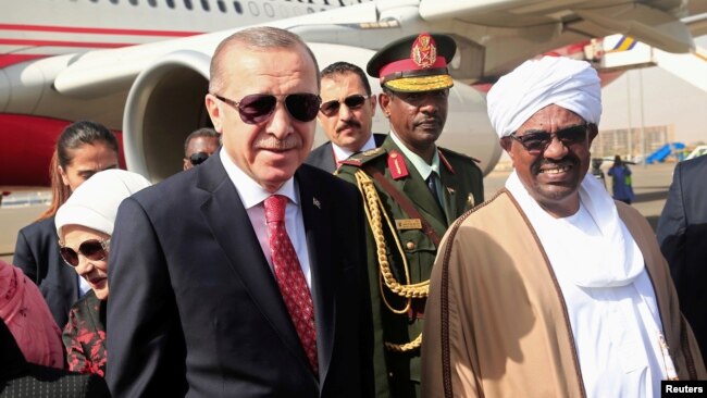 FILE - Sudan’s President Omar al-Bashir welcomes Turkey's President Recep Tayyip Erdogan at Khartoum Airport, Sudan, Dec. 24, 2017. 