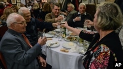People toast with beer and raki, a traditional Turkish aniseed-based alcoholic drink, at an Istanbul restaurant, Turkey, Mar. 16, 2013. 
