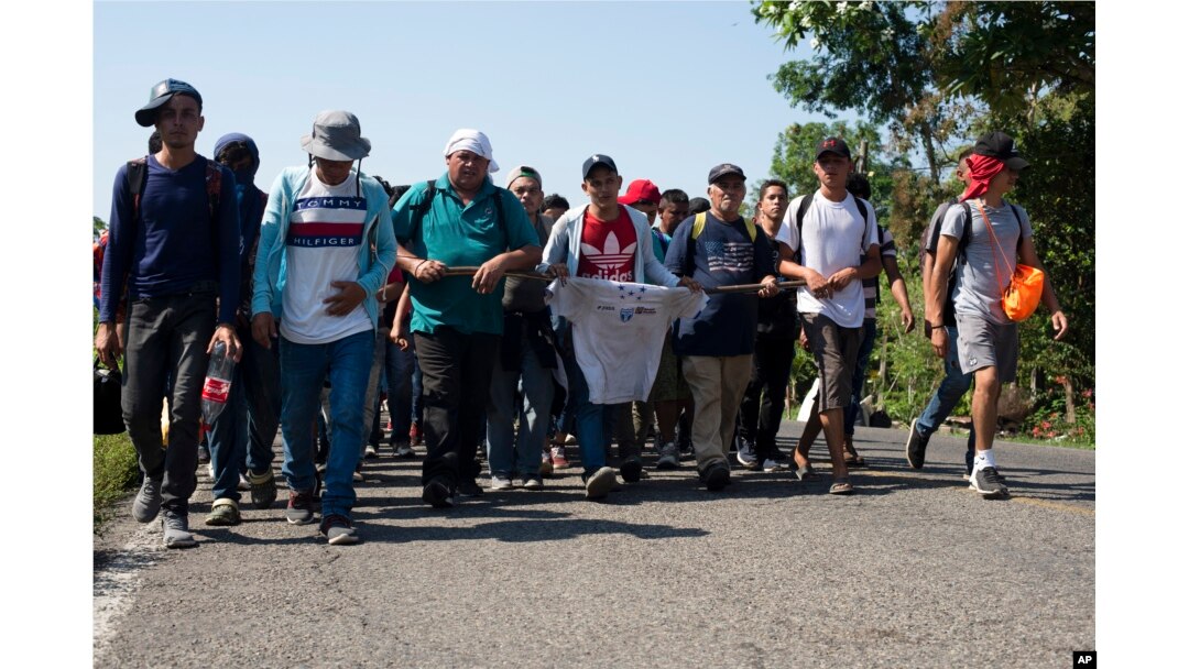 Central American migrants, part of a caravan hoping to reach the U.S. border, walk on a road in Frontera Hidalgo, Mexico, April 12, 2019. The group pushed past police guarding the bridge and joined a group of about 2,000 migrants walking toward Tapachula.