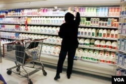 In this March 13, 2007 file photo, a shopper reaches for a milk product at the Acme supermarket in Lawrenceville, N.J.. (AP Photo/Mel Evans, file)