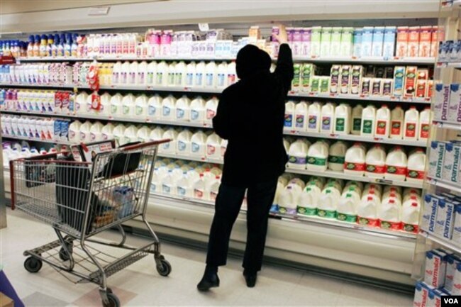 In this March 13, 2007 file photo, a shopper reaches for a milk product at the Acme supermarket in Lawrenceville, N.J.. (AP Photo/Mel Evans, file)