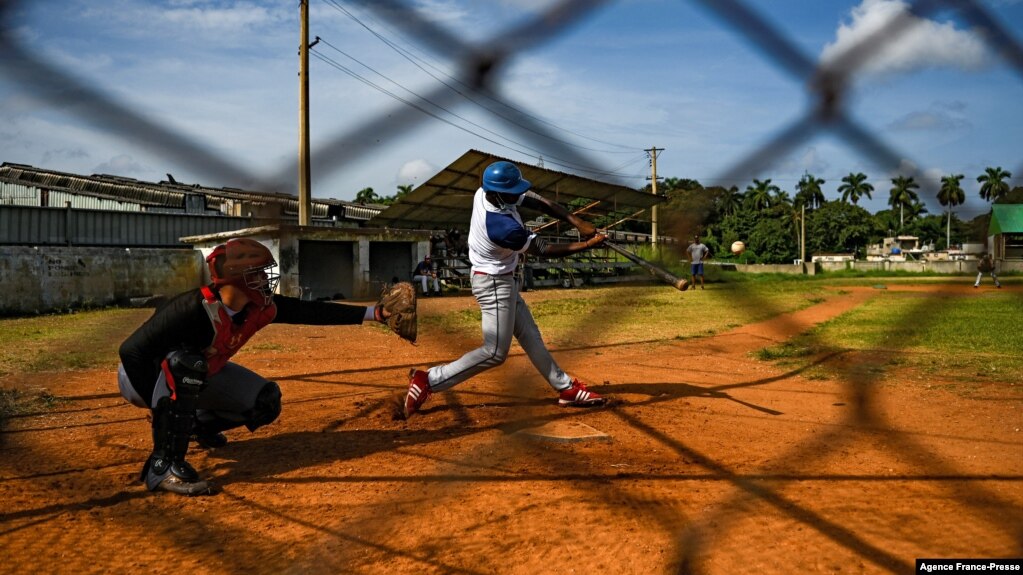 Baseball players play with friends at a field in Havana, Oct. 7, 2021. This year a record number of Cuban baseball players have defected abroad.