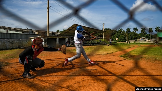 Baseball players play with friends at a field in Havana, Oct. 7, 2021. This year a record number of Cuban baseball players have defected abroad.