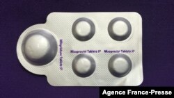 FILE - This image, courtesy of Plan C, shows a combination pack of mifepristone, left, and misoprostol tablets, two medicines used together to induce abortion, May 8, 2020.