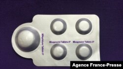 FILE - This image, courtesy of Plan C, shows a combination pack of mifepristone, left, and misoprostol tablets, two medicines used together to induce abortion, May 8, 2020.