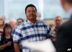 FILE - Fidel Tapia, of Mexico, waits to receive his citizenship in the United States at a naturalization ceremony, May 16, 2019, in Centennial, Colo.