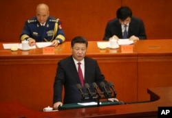 FILE - Chinese President Xi Jinping, bottom, delivers his speech during a ceremony to mark the 95th anniversary of the founding of the Communist Party of China at the Great Hall of the People in Beijing, Friday, July 1, 2016.