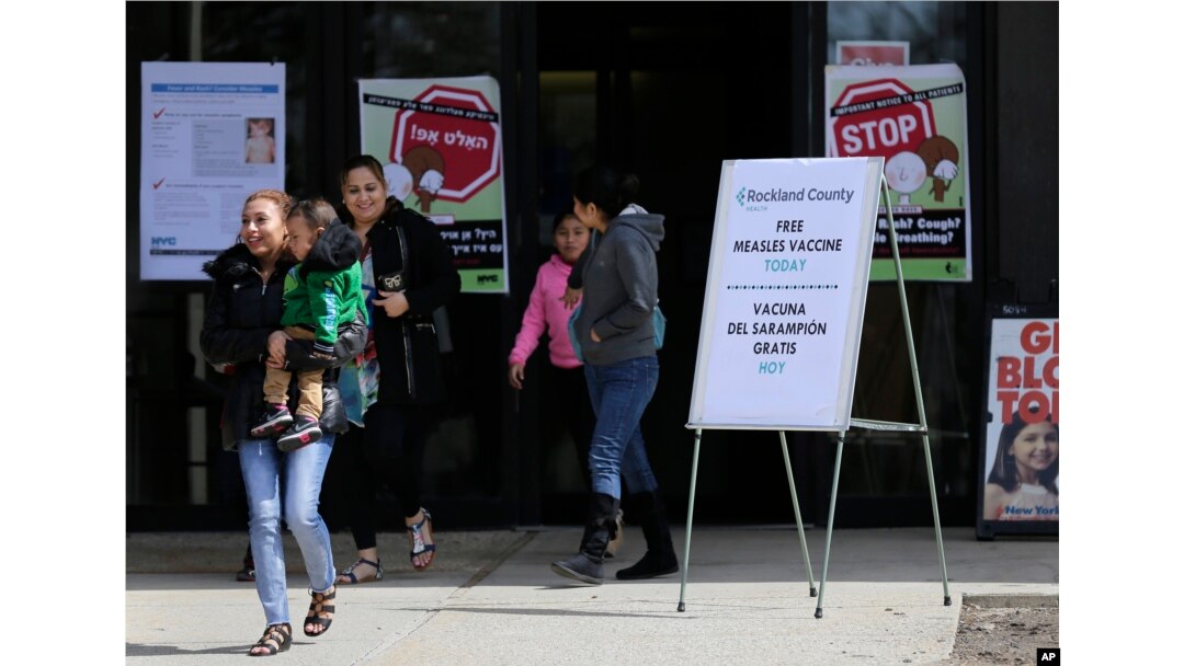 Sign advertising free measles vaccines and information about measles are displayed at the Rockland County Health Department in Pomona, N.Y., March 27, 2019.