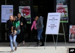 Sign advertising free measles vaccines and information about measles are displayed at the Rockland County Health Department in Pomona, N.Y., March 27, 2019.